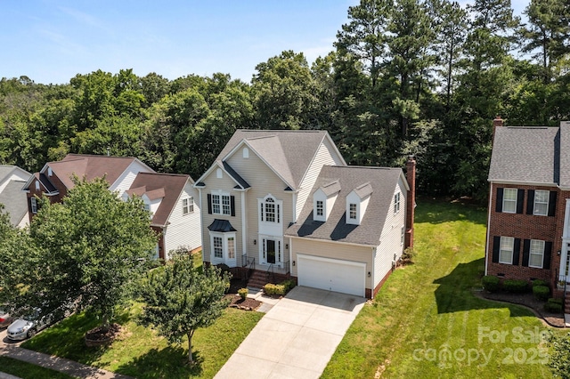 4519 Rock Stream Dr, Charlotte, NC 28269 - traditional-style home featuring concrete driveway, a front yard, and a shingled roof