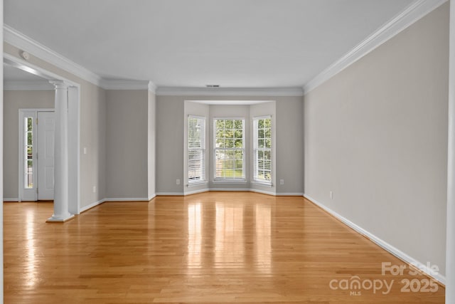 4519 Rock Stream Dr, Charlotte, NC 28269 - unfurnished room featuring decorative columns, light wood-type flooring, and crown molding