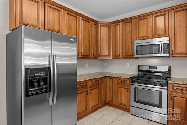 4519 Rock Stream Dr, Charlotte, NC 28269 - kitchen with appliances with stainless steel finishes and brown cabinetry