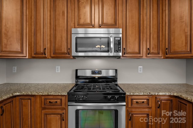 4519 Rock Stream Dr, Charlotte, NC 28269 - kitchen featuring appliances with stainless steel finishes and brown cabinetry