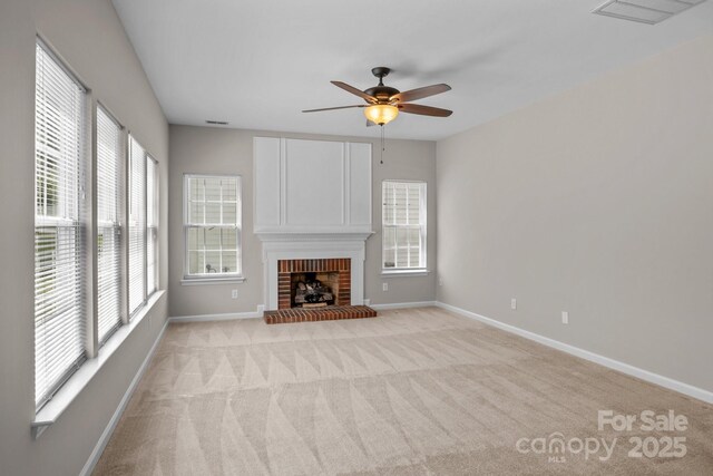 4519 Rock Stream Dr, Charlotte, NC 28269 - unfurnished living room featuring plenty of natural light, a ceiling fan, light carpet, and a fireplace
