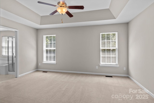 4519 Rock Stream Dr, Charlotte, NC 28269 - spare room with carpet, a tray ceiling, and a ceiling fan