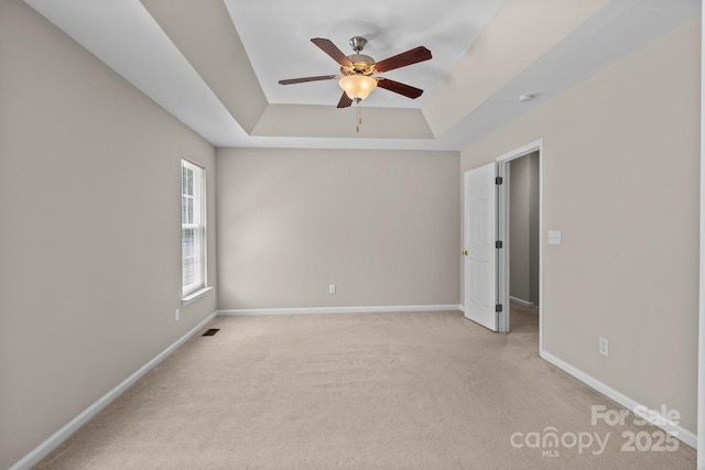 4519 Rock Stream Dr, Charlotte, NC 28269 - spare room featuring a ceiling fan, a raised ceiling, and light colored carpet