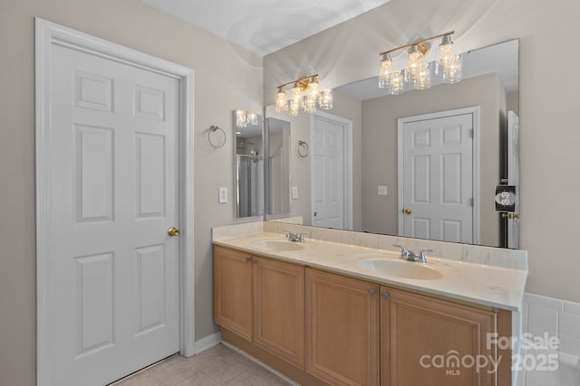 4519 Rock Stream Dr, Charlotte, NC 28269 - bathroom with double vanity, a chandelier, and marble look tiles