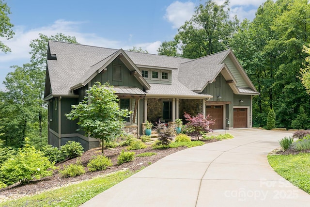 807 Hollybrook Dr, Flat Rock, NC 28731 - craftsman inspired home featuring stone siding, concrete driveway, board and batten siding, a shingled roof, and a porch