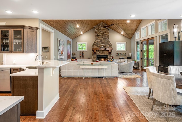 807 Hollybrook Dr, Flat Rock, NC 28731 - kitchen featuring stainless steel dishwasher, open floor plan, wood-type flooring, a stone fireplace, and wood ceiling