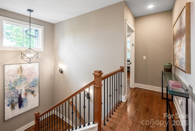 807 Hollybrook Dr, Flat Rock, NC 28731 - corridor featuring wood finished floors, a chandelier, and an upstairs landing