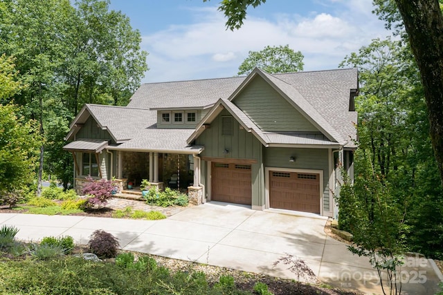 807 Hollybrook Dr, Flat Rock, NC 28731 - craftsman-style house with board and batten siding, concrete driveway, a shingled roof, stone siding, and a porch