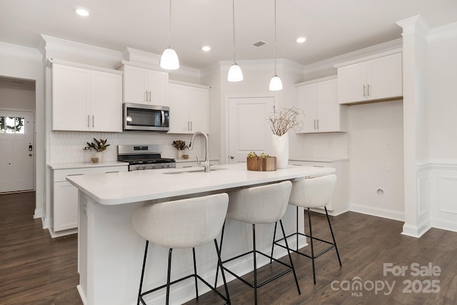 123 S Shayna Rd, Troutman, NC 28166 - kitchen featuring appliances with stainless steel finishes, backsplash, white cabinets, dark wood-style flooring, and light countertops