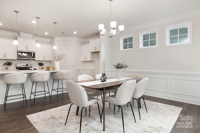 123 S Shayna Rd, Troutman, NC 28166 - dining area featuring crown molding, dark wood-style floors, a chandelier, recessed lighting, and a decorative wall