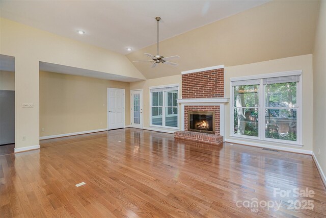 140 Rustic Way Ln, Mooresville, NC 28117 - unfurnished living room featuring vaulted ceiling, ceiling fan, wood finished floors, and a fireplace