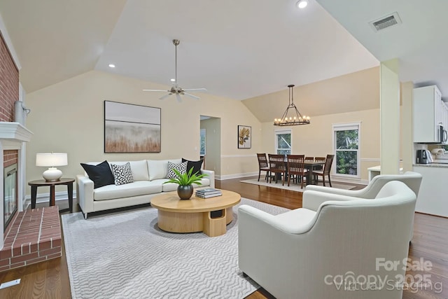 140 Rustic Way Ln, Mooresville, NC 28117 - living area featuring lofted ceiling, wood finished floors, a fireplace, a ceiling fan, and recessed lighting