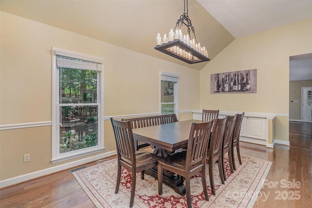 140 Rustic Way Ln, Mooresville, NC 28117 - dining area featuring wood finished floors, lofted ceiling, and a chandelier