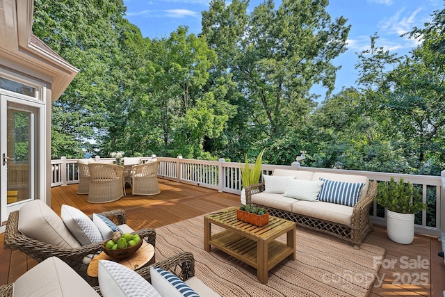 15724 Eagleview Dr, Charlotte, NC 28278 - wooden deck with outdoor lounge area, outdoor dining area, and view of wooded area