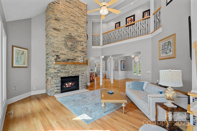 15724 Eagleview Dr, Charlotte, NC 28278 - living area featuring ceiling fan, wood finished floors, a high ceiling, and a fireplace