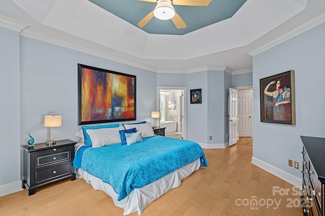 15724 Eagleview Dr, Charlotte, NC 28278 - bedroom featuring a tray ceiling, wood finished floors, crown molding, connected bathroom, and a ceiling fan