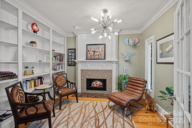 15724 Eagleview Dr, Charlotte, NC 28278 - sitting room with light wood finished floors, a chandelier, ornamental molding, a tiled fireplace, and built in features