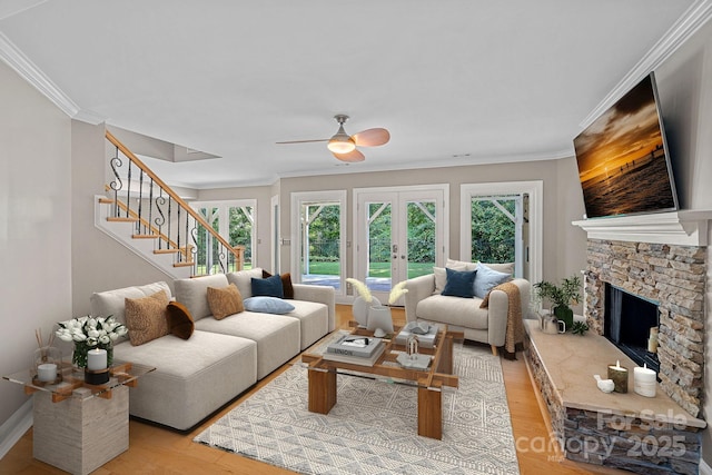 15724 Eagleview Dr, Charlotte, NC 28278 - living area with light wood-type flooring, stairway, ornamental molding, a stone fireplace, and ceiling fan