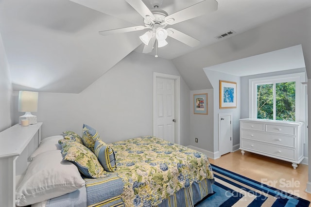 15724 Eagleview Dr, Charlotte, NC 28278 - bedroom with lofted ceiling, wood finished floors, and a ceiling fan