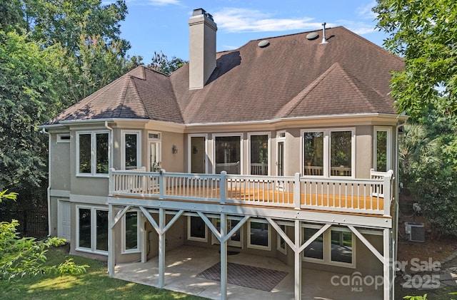 15724 Eagleview Dr, Charlotte, NC 28278 - back of house featuring stucco siding, a chimney, a patio, and roof with shingles