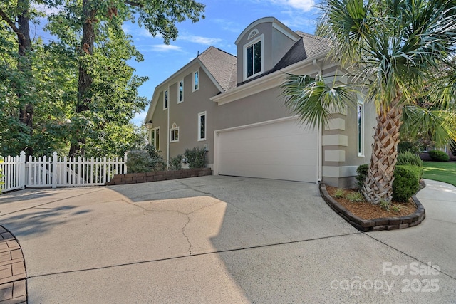 15724 Eagleview Dr, Charlotte, NC 28278 - view of property exterior with stucco siding, driveway, an attached garage, and roof with shingles