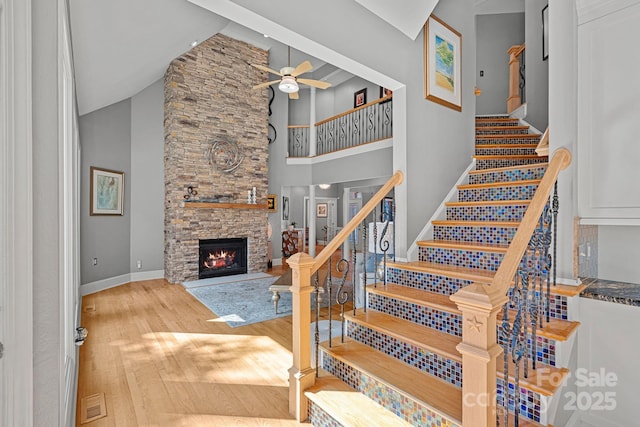 15724 Eagleview Dr, Charlotte, NC 28278 - stairs with a ceiling fan, a fireplace, wood finished floors, and high vaulted ceiling