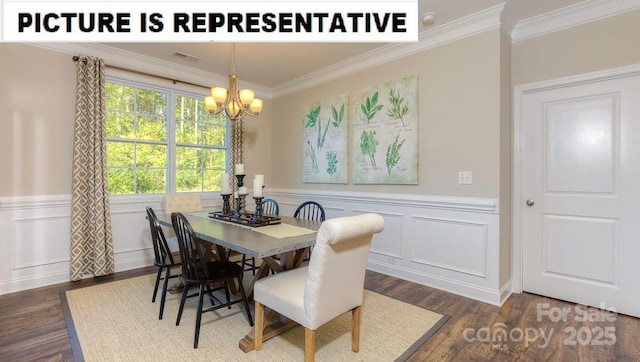 502 York Rd, Troutman, NC 28166 - dining space with crown molding, a chandelier, dark wood-type flooring, wainscoting, and a decorative wall