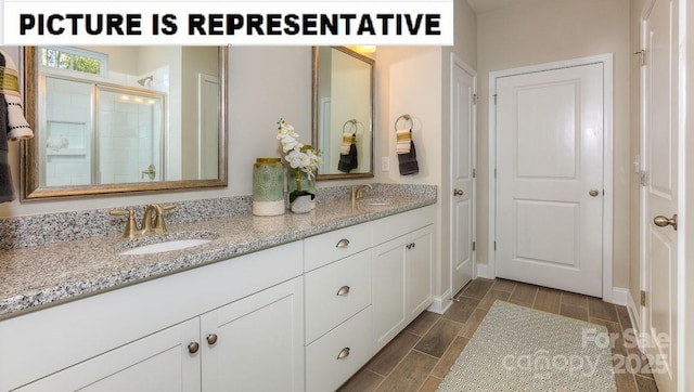 502 York Rd, Troutman, NC 28166 - bathroom featuring double vanity, tiled shower, and wood tiled floors