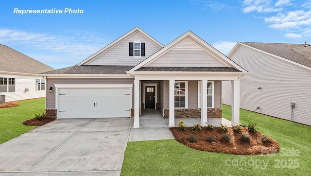 502 York Rd, Troutman, NC 28166 - view of front of house with driveway, an attached garage, covered porch, a front yard, and brick siding