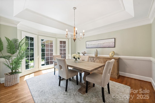2317 Houston Branch Rd, Charlotte, NC 28270 - dining room featuring a raised ceiling, a chandelier, light wood finished floors, and crown molding