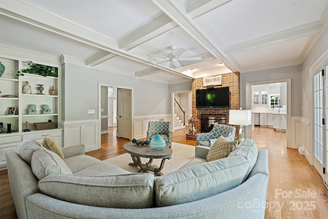 2317 Houston Branch Rd, Charlotte, NC 28270 - living room with coffered ceiling, light wood-style flooring, beamed ceiling, stairway, and a wainscoted wall