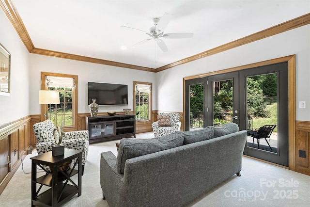 2317 Houston Branch Rd, Charlotte, NC 28270 - living room with a wainscoted wall, light colored carpet, a ceiling fan, and ornamental molding
