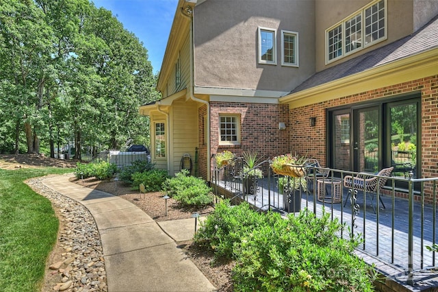 2317 Houston Branch Rd, Charlotte, NC 28270 - property entrance featuring brick siding, stucco siding, and outdoor dining space