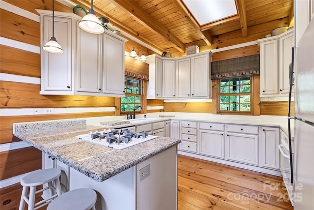 35 Elderberry Dr Unit 805, Old Fort, NC 28762 - kitchen with a wooden ceiling with exposed beams, white appliances, light wood-type flooring, a kitchen bar, and decorative light fixtures