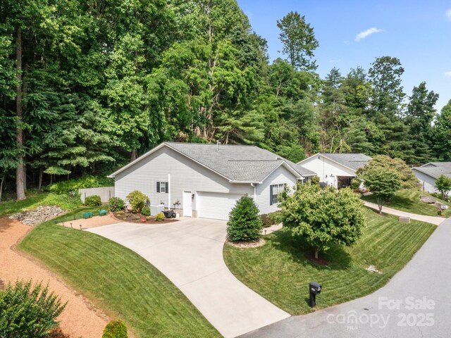 670 New Village Dr, Hendersonville, NC 28791 - ranch-style house featuring concrete driveway, a front yard, and an attached garage