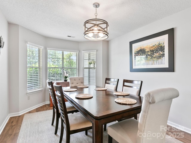 670 New Village Dr, Hendersonville, NC 28791 - dining room featuring a chandelier, a textured ceiling, and wood finished floors