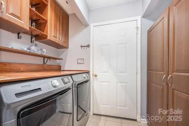 2070 Rocketts Way, Newton, NC 28658 - washroom featuring cabinet space, washing machine and dryer, and light tile patterned flooring