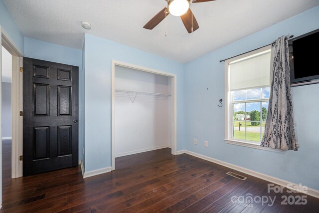 2070 Rocketts Way, Newton, NC 28658 - unfurnished bedroom with dark wood finished floors, a closet, and a ceiling fan