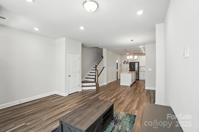 334 Ladybird Ln, Pineville, NC 28134 - unfurnished living room with dark wood-type flooring, stairway, recessed lighting, and a chandelier