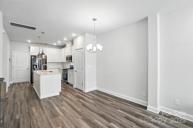 334 Ladybird Ln, Pineville, NC 28134 - kitchen featuring appliances with stainless steel finishes, a chandelier, dark wood-type flooring, light countertops, and white cabinets