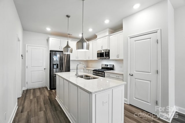 334 Ladybird Ln, Pineville, NC 28134 - kitchen with stainless steel appliances, white cabinets, dark wood-style flooring, decorative backsplash, and an island with sink