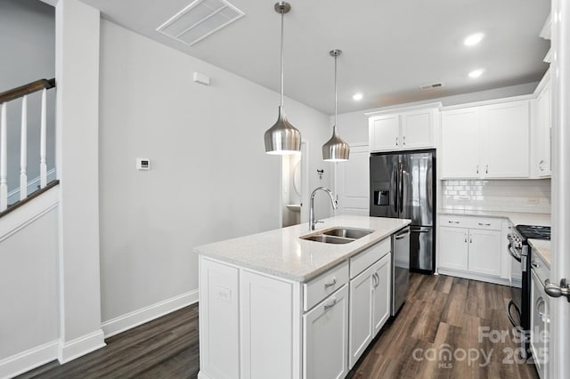 334 Ladybird Ln, Pineville, NC 28134 - kitchen with stainless steel appliances, dark wood-style floors, tasteful backsplash, recessed lighting, and a center island with sink