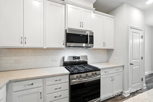 334 Ladybird Ln, Pineville, NC 28134 - kitchen featuring stainless steel appliances, white cabinets, backsplash, and dark wood-style floors