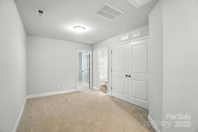 334 Ladybird Ln, Pineville, NC 28134 - unfurnished bedroom featuring carpet flooring, ensuite bathroom, and a closet