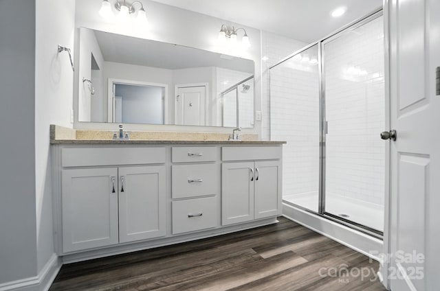334 Ladybird Ln, Pineville, NC 28134 - full bathroom with double vanity, a shower stall, and wood finished floors