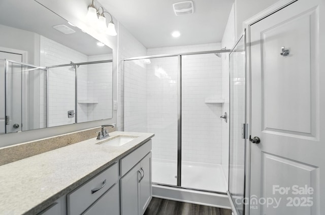 334 Ladybird Ln, Pineville, NC 28134 - full bathroom featuring vanity, a stall shower, wood finished floors, and recessed lighting