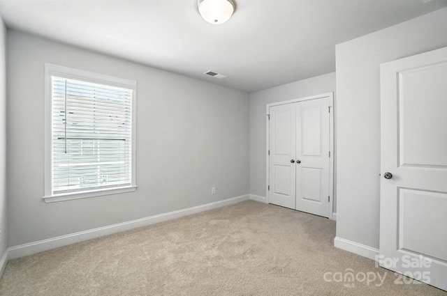 334 Ladybird Ln, Pineville, NC 28134 - unfurnished bedroom featuring light colored carpet and a closet