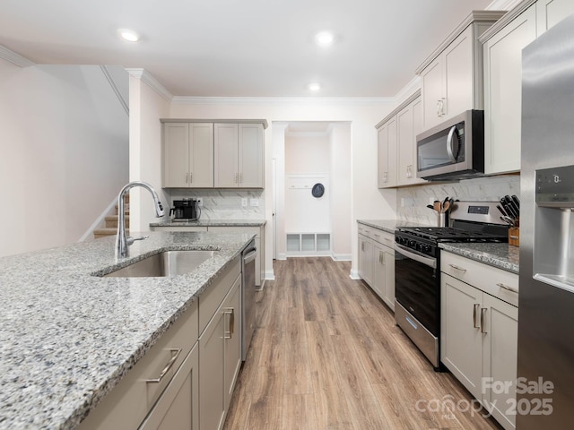 4177 Steel Way, Sherrills Ford, NC 28673 - kitchen featuring appliances with stainless steel finishes, gray cabinets, backsplash, light wood-style flooring, and light stone countertops