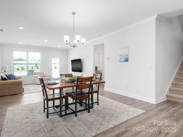 4177 Steel Way, Sherrills Ford, NC 28673 - dining room with ornamental molding, a chandelier, light wood finished floors, stairway, and recessed lighting