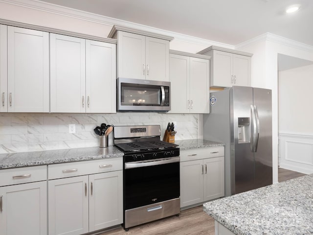 4177 Steel Way, Sherrills Ford, NC 28673 - kitchen with appliances with stainless steel finishes, crown molding, light stone counters, light wood-style floors, and tasteful backsplash